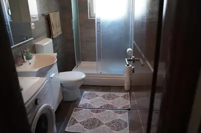 a bathroom with a shower and a toilet and a sink at apartman Vidović in Livno
