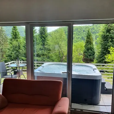 a large tub sitting on a screened in porch at WOLF'S PLANE Luxury Isolated Mountain House for Digital Nomads in Fojnica