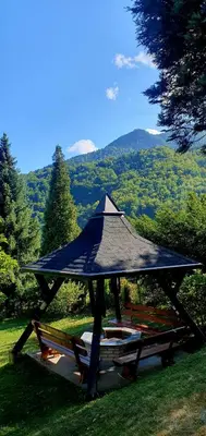 a gazebo with a roof on the grass at WOLF'S PLANE Luxury Isolated Mountain House for Digital Nomads in Fojnica
