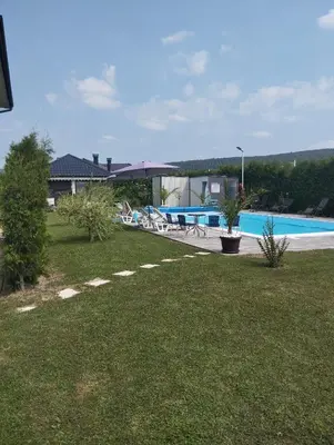 a yard with a swimming pool and a house at City villa Bihac in Bihać