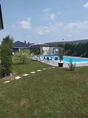 a yard with a swimming pool and a house at City villa Bihac in Bihać