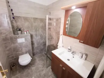 a bathroom with a sink and a toilet and a mirror at Motel Liberta in Jajce
