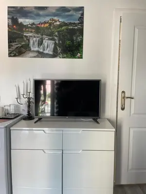 a tv on top of a white dresser in a room at Motel Liberta in Jajce