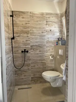 a bathroom with a toilet and a shower at Motel Liberta in Jajce