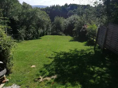 a large yard with green grass and trees at Ravne Rest House in Visoko
