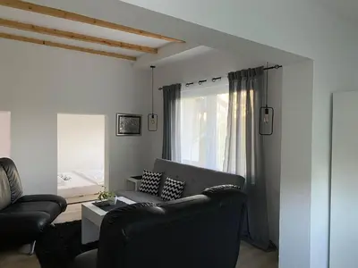 a living room with a couch and a window at Ravne Rest House in Visoko