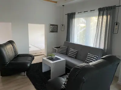 a living room with two chairs and a couch at Ravne Rest House in Visoko