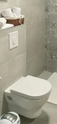 a bathroom with a toilet and a shower with towels at Ravne Rest House in Visoko
