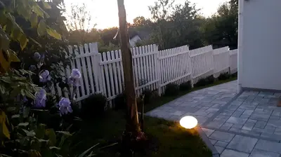 a white picket fence with a candle in the yard at Ravne Rest House in Visoko