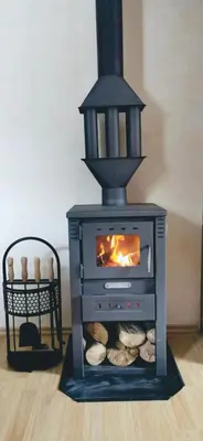 a stove with a fireplace in a room at Apartman Spirit of Vlašić in Vlasic