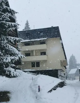 a building in the snow in front at Apartman Spirit of Vlašić in Vlasic