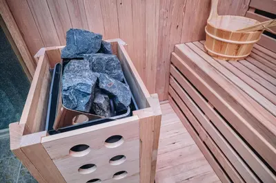a wooden box with rocks in a sauna at Ribarski konaci in Doboj