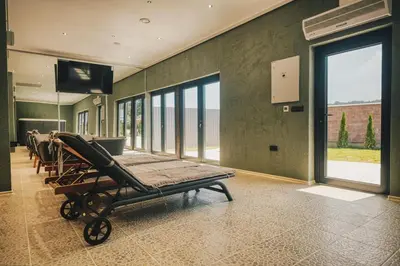 a hospital room with a bed and a flat screen tv at Ribarski konaci in Doboj