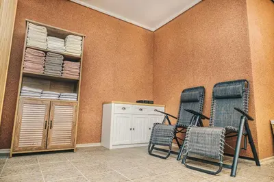 two chairs in a room with a closet at Ribarski konaci in Doboj