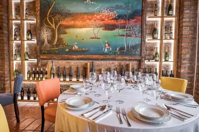 a table in a restaurant with wine glasses on it at Ribarski konaci in Doboj