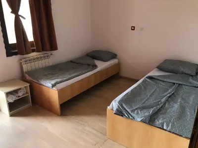 a bedroom with two beds and a window at Sound apartment in Fojnica