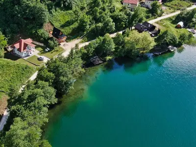 an aerial view of a lake with a house at Malena Plivsko Jezero Jajce in Jajce