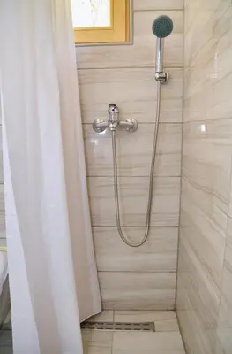 a shower with a shower curtain in a bathroom at Malena Plivsko Jezero Jajce in Jajce
