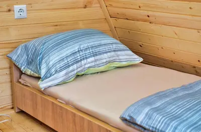 a bed in a room with a pillow on it at Malena Plivsko Jezero Jajce in Jajce
