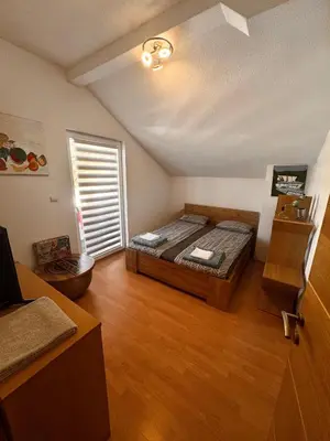 a bedroom with a bed in a room with a window at Kuća za odmor Aiman in Mahala