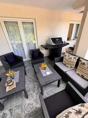 a living room with couches and tables and a piano at Kuća za odmor Aiman in Mahala