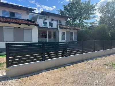 a fence in front of a house at Nisa & De Apartmani in Bihać