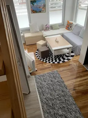 a living room with a couch and a table at Nisa & De Apartmani in Bihać