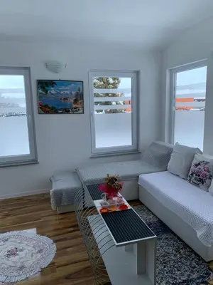 a living room with a couch and a table at Nisa & De Apartmani in Bihać
