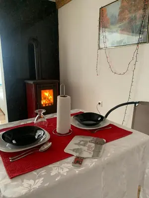 a table with two plates and a candle on it at Nisa & De Apartmani in Bihać