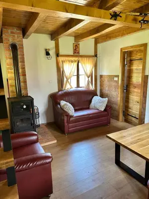 a living room with a couch and a wood stove at Vikendica na Janju in Šipovo