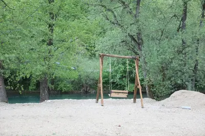 a swing in the sand in a park at Vikendica na Janju in Šipovo