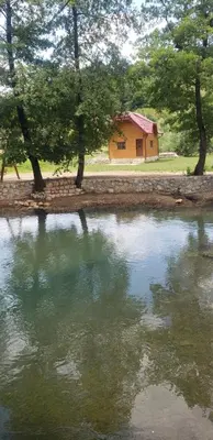 a house next to a body of water at Vikendica na Janju in Šipovo
