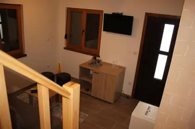 a room with a staircase and a door with a television at Sherwood resort in Bihać