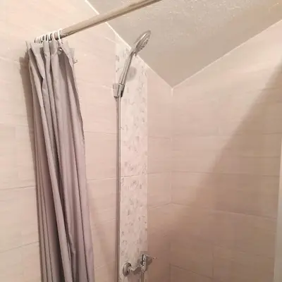 a shower with a shower curtain in a bathroom at King's Cave in Jajce