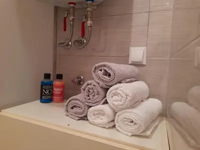 a pile of towels sitting on a shelf in a bathroom at King's Cave in Jajce