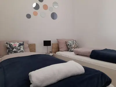 a bedroom with two beds and a couch at King's Cave in Jajce