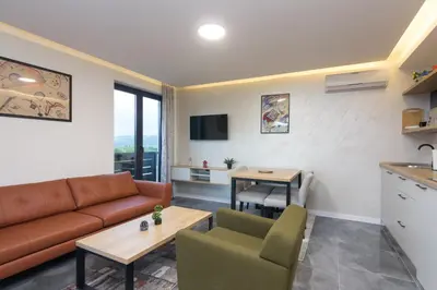 a living room with a couch and a table at Deluxe Feliciano Apartments in Visoko
