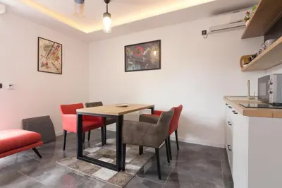 a kitchen and dining room with a table and chairs at Deluxe Feliciano Apartments in Visoko