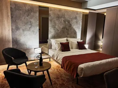 a hotel room with a bed and a chair at Hotel City Code in Zenica