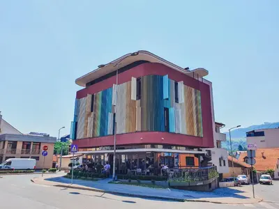 a building with a lot of windows on a street at Hotel City Code in Zenica