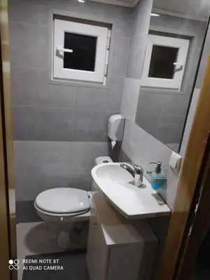 a bathroom with a toilet and a sink and a mirror at Lenilenii Bungalows in Jajce