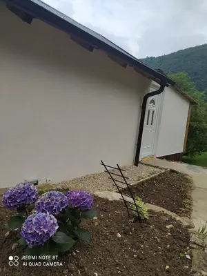 a building with purple flowers in front of it at Lenilenii Bungalows in Jajce