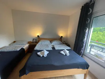two twin beds in a room with a window at Una Verde in Bihać