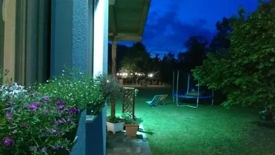 a garden at night with a table and plants at Una Verde in Bihać