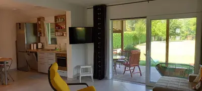 a kitchen and living room with a sliding glass door at Una Verde in Bihać