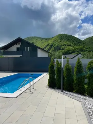 a backyard with a swimming pool and a house at Apartments B&M in Visoko