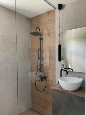 a bathroom with a sink and a shower at Apartments B&M in Visoko