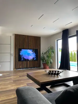 a living room with a coffee table and a tv at Apartments B&M in Visoko