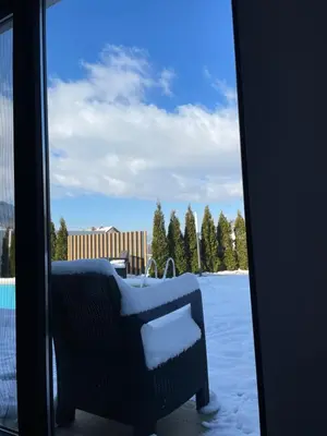 a sliding glass door with snow on a patio at Apartments B&M in Visoko