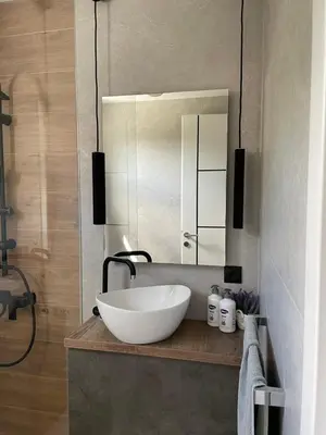 a bathroom with a sink and a mirror at Apartments B&M in Visoko
